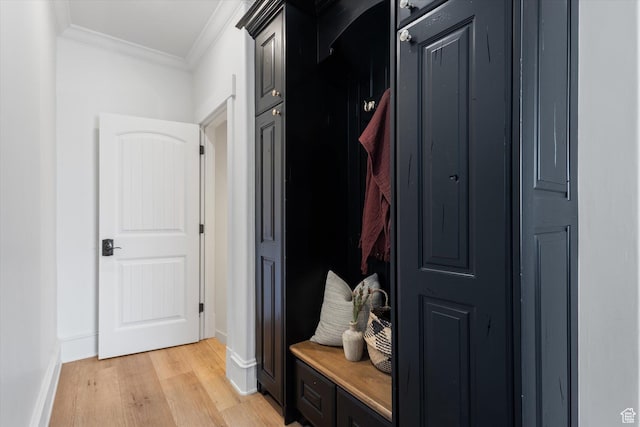 mudroom featuring light wood-style flooring, crown molding, and baseboards