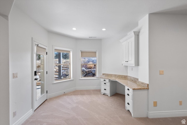 unfurnished office featuring recessed lighting, built in study area, visible vents, light carpet, and baseboards