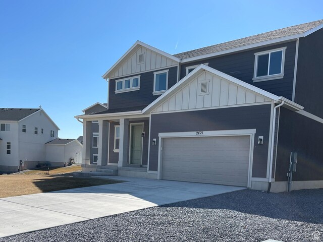 2421 S Blue Water Ln E, Saratoga Springs, UT 84045 - view of front of house featuring concrete driveway and board and batten siding