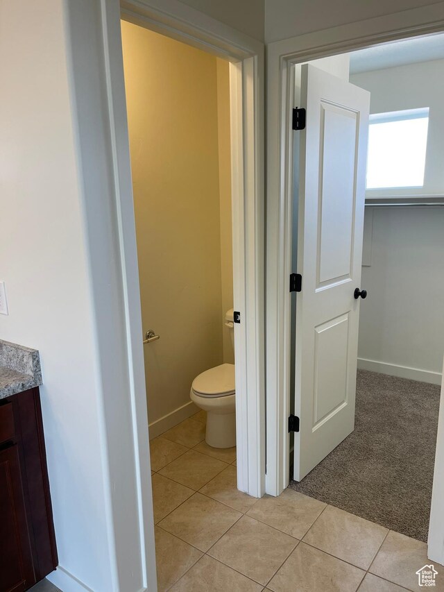 2421 S Blue Water Ln E, Saratoga Springs, UT 84045 - bathroom with toilet, vanity, baseboards, and tile patterned flooring