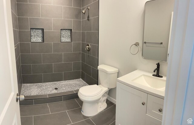 2421 S Blue Water Ln E, Saratoga Springs, UT 84045 - full bath with tile patterned floors, tiled shower, vanity, and toilet