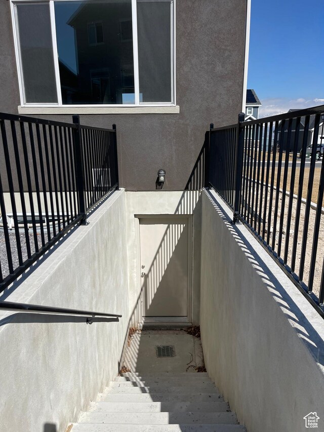 2421 S Blue Water Ln E, Saratoga Springs, UT 84045 - doorway to property featuring stucco siding and a balcony