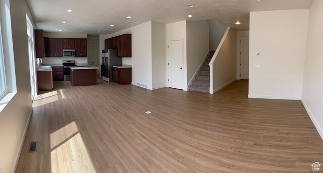 2421 S Blue Water Ln E, Saratoga Springs, UT 84045 - unfurnished living room with visible vents, recessed lighting, stairs, light wood finished floors, and baseboards