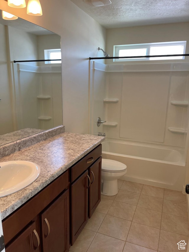 2421 S Blue Water Ln E, Saratoga Springs, UT 84045 - bathroom featuring washtub / shower combination, toilet, a textured ceiling, vanity, and tile patterned floors