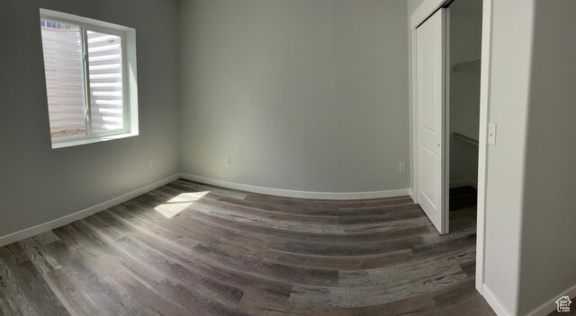 2421 S Blue Water Ln E, Saratoga Springs, UT 84045 - unfurnished bedroom featuring a closet, baseboards, and dark wood finished floors