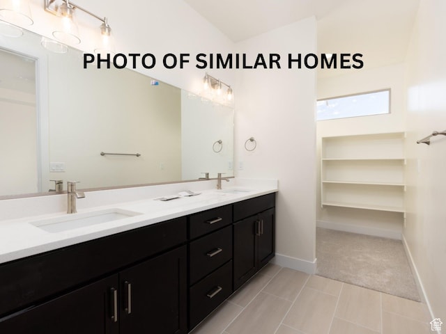2129 W 320 S, Hurricane, UT 84737 - full bath featuring double vanity, baseboards, lofted ceiling, and a sink