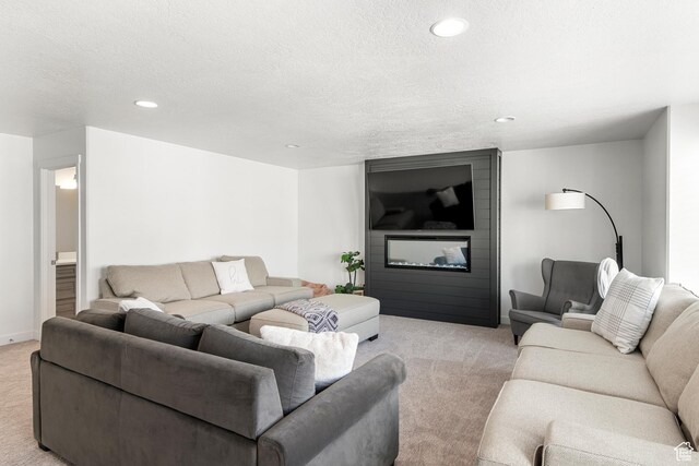 529 Richland Valley St, Garden City, UT 84028 - living area featuring recessed lighting, a large fireplace, light colored carpet, and a textured ceiling