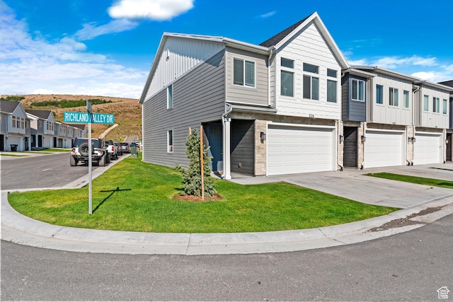 529 Richland Valley St, Garden City, UT 84028 - multi unit property with board and batten siding, a residential view, a front yard, a garage, and driveway