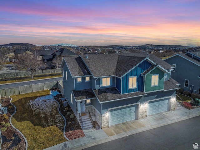 3323 E Gibraltar Ave, Eagle Mountain, UT 84005 - view of front facade with an attached garage, fence, board and batten siding, and roof with shingles