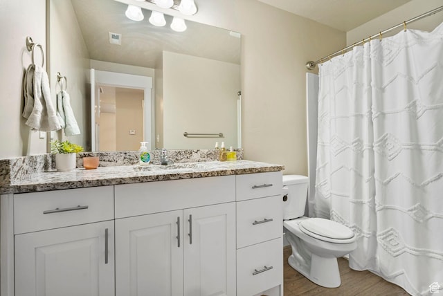 3323 E Gibraltar Ave, Eagle Mountain, UT 84005 - bathroom with visible vents, toilet, wood finished floors, and vanity