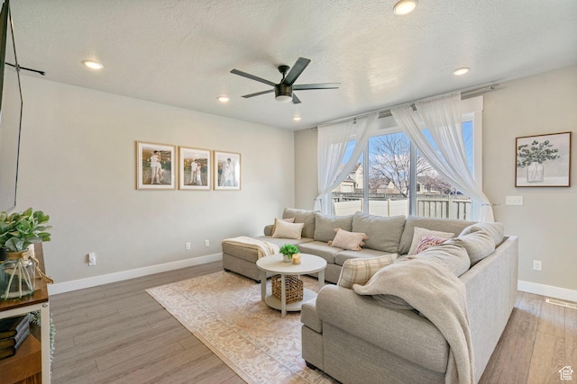 3323 E Gibraltar Ave, Eagle Mountain, UT 84005 - living room featuring a ceiling fan, baseboards, recessed lighting, a textured ceiling, and light wood-type flooring