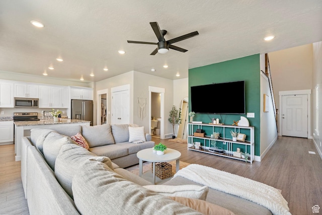 3323 E Gibraltar Ave, Eagle Mountain, UT 84005 - living area featuring recessed lighting, baseboards, light wood-style floors, and a ceiling fan