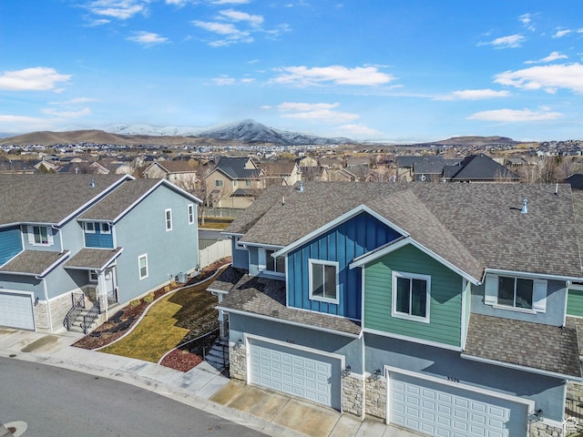 3323 E Gibraltar Ave, Eagle Mountain, UT 84005 - view of front facade featuring a mountain view, a residential view, board and batten siding, and a shingled roof