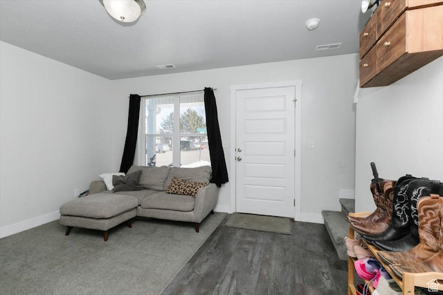 living room featuring dark wood finished floors, baseboards, and visible vents