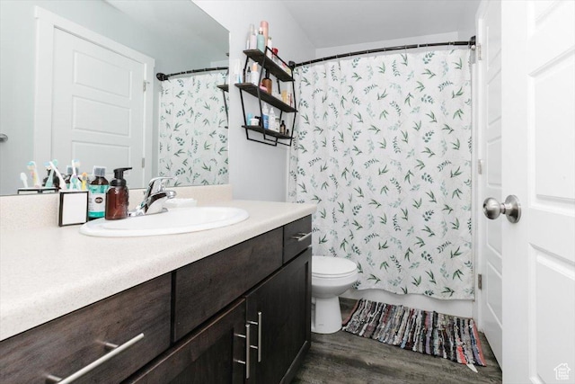 bathroom with shower / tub combo, toilet, wood finished floors, and vanity