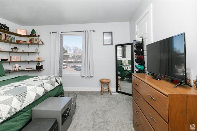 bedroom with light colored carpet and baseboards