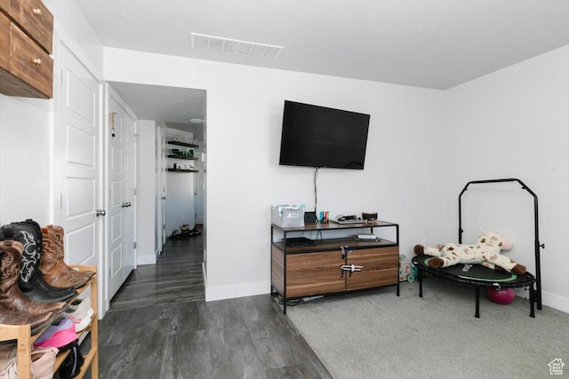 interior space with visible vents, baseboards, and wood finished floors
