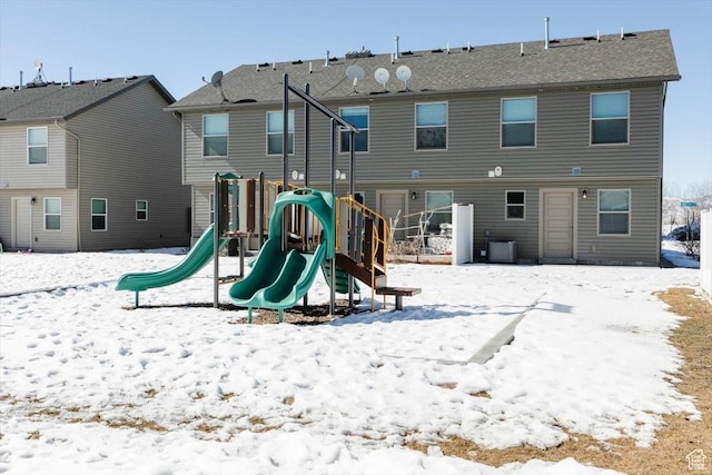 snow covered playground with a playground and central AC