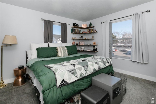 carpeted bedroom featuring multiple windows and baseboards