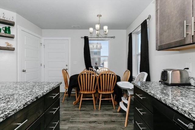 dining room with visible vents, dark wood-type flooring, and an inviting chandelier