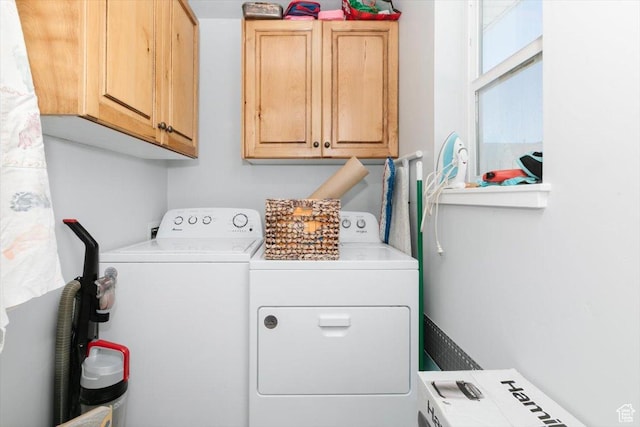 laundry room with cabinet space and washing machine and clothes dryer
