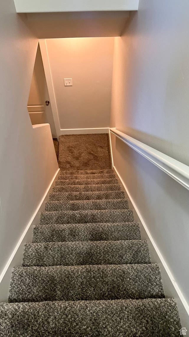 stairway with carpet flooring and baseboards