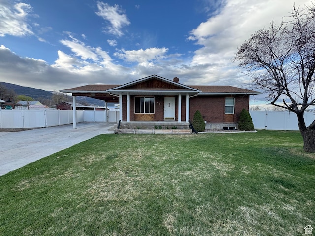 350 S 50 W, Ephraim, UT 84627 - ranch-style house featuring concrete driveway, a carport, fence, a front yard, and brick siding