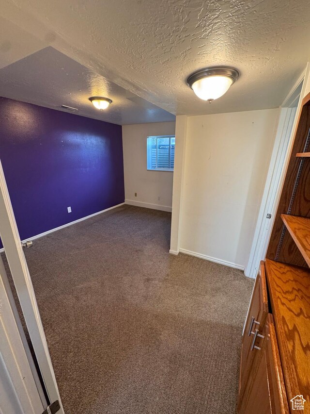 350 S 50 W, Ephraim, UT 84627 - spare room featuring dark carpet, a textured ceiling, baseboards, and visible vents