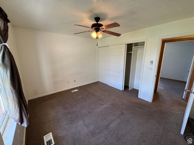 350 S 50 W, Ephraim, UT 84627 - unfurnished bedroom with a closet, a ceiling fan, visible vents, dark colored carpet, and baseboards