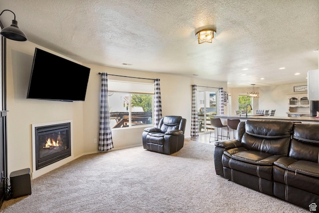 5943 N Bleeker, Stansbury Park, UT 84074 - carpeted living room with a textured ceiling, a glass covered fireplace, and recessed lighting