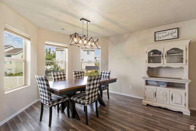 5943 N Bleeker, Stansbury Park, UT 84074 - dining space with dark wood-type flooring, a chandelier, and a textured ceiling