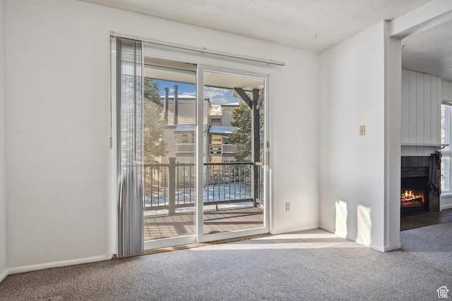 1900 Homestake Rd Unit 32, Park City, UT 84060 - carpeted spare room featuring a fireplace with flush hearth, a textured ceiling, and baseboards