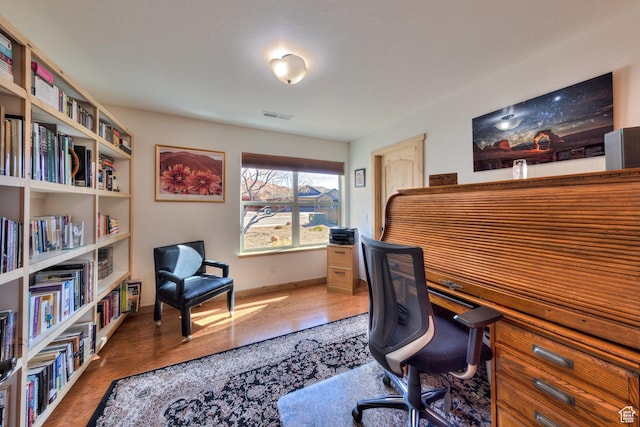 827 N Palisade Dr, Moab, UT 84532 - office area with visible vents, baseboards, and wood finished floors