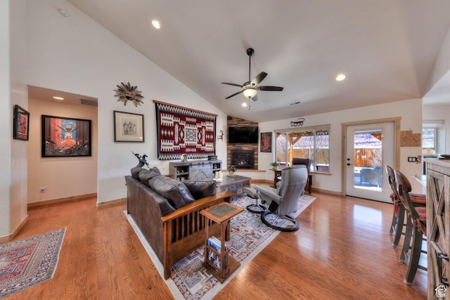 827 N Palisade Dr, Moab, UT 84532 - living area featuring visible vents, light wood-style floors, a stone fireplace, and a ceiling fan