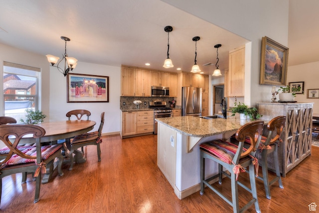 827 N Palisade Dr, Moab, UT 84532 - kitchen featuring light brown cabinetry, a sink, tasteful backsplash, stainless steel appliances, and a peninsula