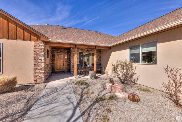 827 N Palisade Dr, Moab, UT 84532 - entrance to property featuring stone siding, roof with shingles, and stucco siding