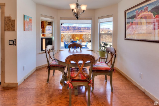 827 N Palisade Dr, Moab, UT 84532 - dining area featuring baseboards, an inviting chandelier, and light wood-style flooring