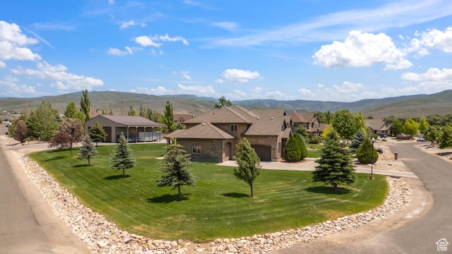 1865 S 3350 E, Heber City, UT 84032 - view of front of property featuring a mountain view, stone siding, a front yard, and curved driveway
