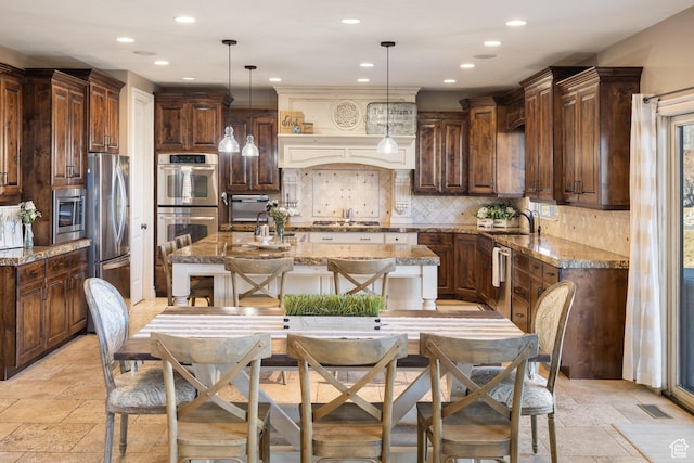1865 S 3350 E, Heber City, UT 84032 - kitchen featuring stainless steel appliances, recessed lighting, a center island with sink, light stone countertops, and decorative backsplash