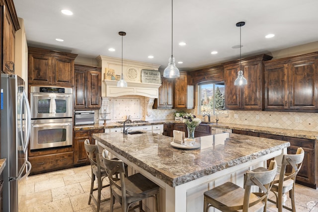 1865 S 3350 E, Heber City, UT 84032 - kitchen featuring stainless steel appliances, a breakfast bar, an island with sink, recessed lighting, and tasteful backsplash