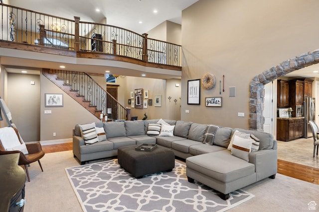 1865 S 3350 E, Heber City, UT 84032 - living area with light wood-type flooring, stairs, a towering ceiling, and recessed lighting