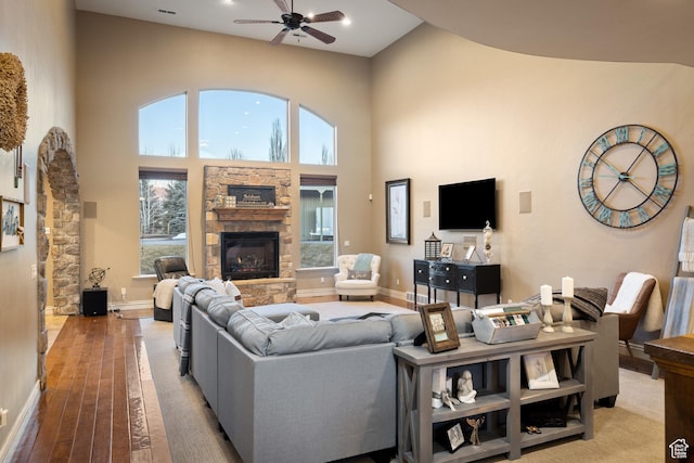 1865 S 3350 E, Heber City, UT 84032 - living room featuring a stone fireplace, ceiling fan, light wood-type flooring, a towering ceiling, and recessed lighting