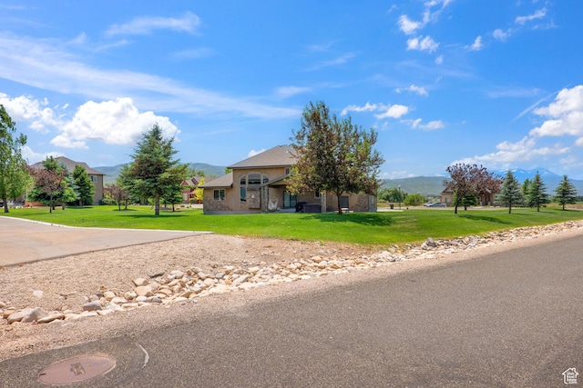 1865 S 3350 E, Heber City, UT 84032 - view of property hidden behind natural elements with a mountain view, a front lawn, and stucco siding