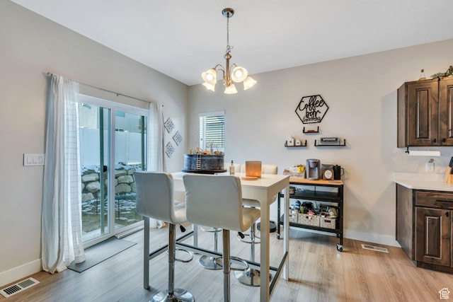 1186 N Buckboard Ln, Spanish Fork, UT 84660 - dining room with light wood-type flooring, an inviting chandelier, baseboards, and visible vents