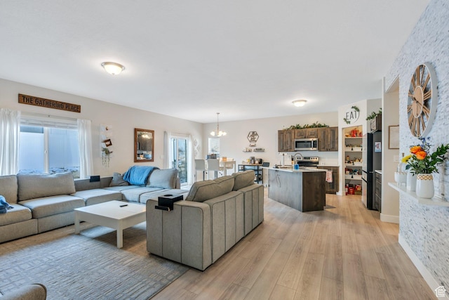1186 N Buckboard Ln, Spanish Fork, UT 84660 - living area featuring light wood-style floors and an inviting chandelier