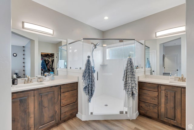1186 N Buckboard Ln, Spanish Fork, UT 84660 - bathroom with a sink, two vanities, a stall shower, and wood finished floors