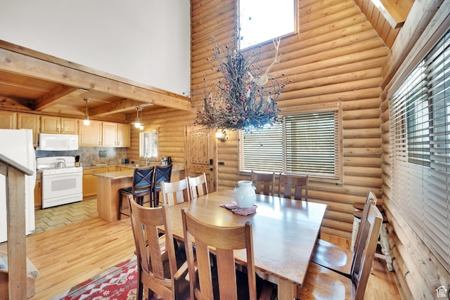 2821 S Deer Run Rd Unit 1011C, Heber City, UT 84032 - dining room with beamed ceiling, light wood finished floors, and a towering ceiling