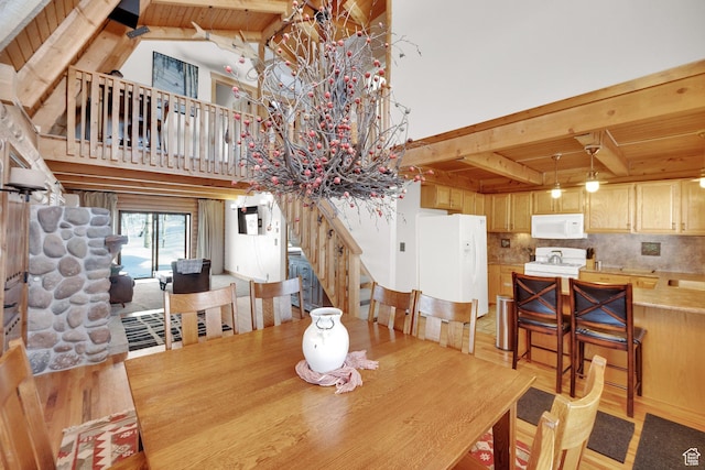 2821 S Deer Run Rd Unit 1011C, Heber City, UT 84032 - dining area featuring beam ceiling, light wood finished floors, wood ceiling, and a towering ceiling