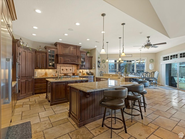 14738 S Currant Creek Cir W, Bluffdale, UT 84065 - kitchen featuring a large island, recessed lighting, decorative backsplash, stone tile floors, and a kitchen bar