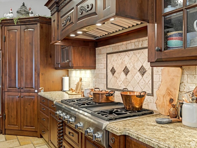 14738 S Currant Creek Cir W, Bluffdale, UT 84065 - kitchen featuring stainless steel gas stovetop, light stone countertops, tasteful backsplash, glass insert cabinets, and light stone finish flooring